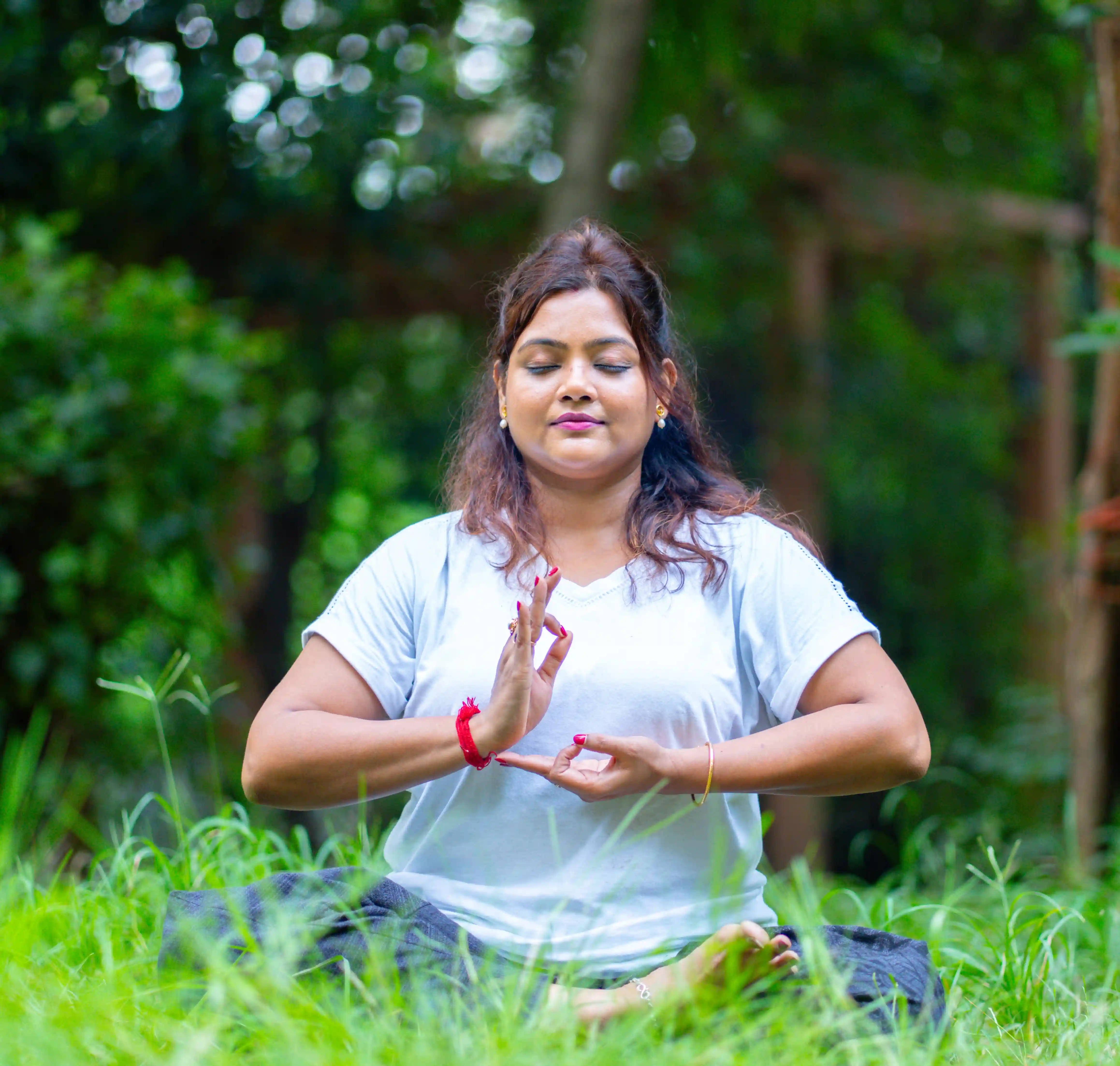 A certified yoga instructor leading a class, representing the professional career benefits of a yoga and meditation teacher training program.